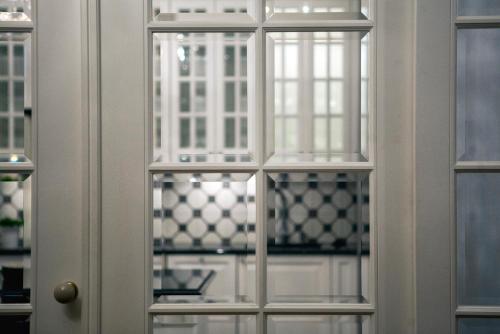 a white door with glass windows in a room at 7 Koron - Exclusive Apartments in Kraków