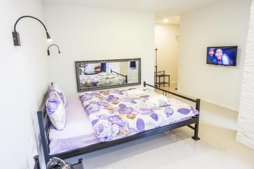 a hospital bed in a room with a picture on the wall at Aloha Apartments with pool in Skopje