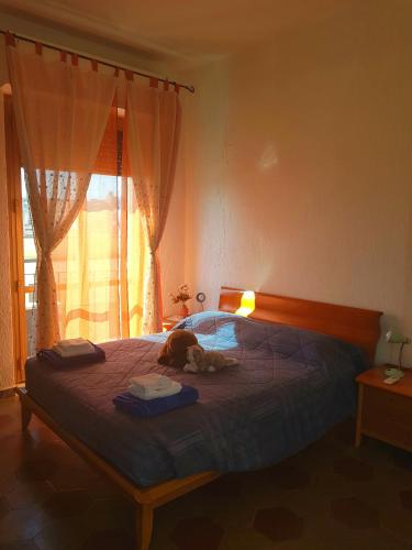a bedroom with a large bed with a stuffed animal on it at Robta's Dream Home in Rome