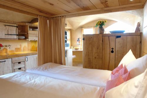 a bedroom with a bed in a room with a kitchen at Turm zu Schloss Schedling in Trostberg an der Alz