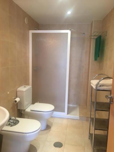 a bathroom with a toilet and a shower at Alameda Apartments in Benidorm