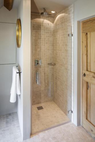 a shower with a glass door in a bathroom at B&B De Lievde in Lievegem