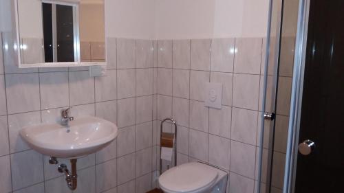 a bathroom with a sink and a toilet at Gästehaus Apartments B & B27 und Pension Waldhorn in Rottweil