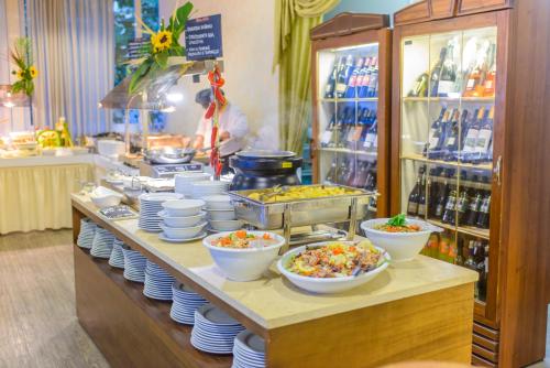 a buffet line with bowls and plates of food at Hotel Cristallo in Riccione