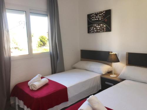 a room with two beds and a window at Anacasa Oasis Beach II Marineta AP2116 in Denia