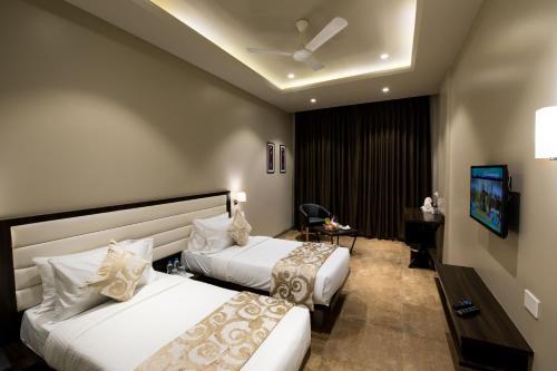 Posteľ alebo postele v izbe v ubytovaní Enrise By Sayaji Ahmednagar