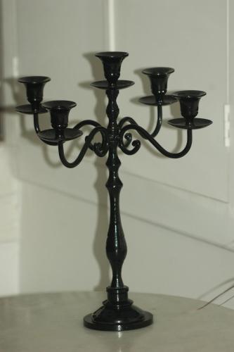 a black candle stand with lights on a wall at Quai 17 Maison d'hôtes in Strasbourg
