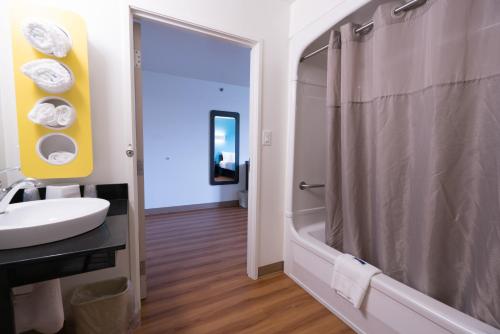 a bathroom with a sink and a tub and a shower at Motel 6-Pottstown, PA in Pottstown