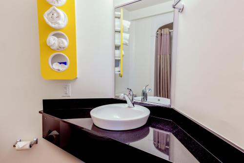 a bathroom with a sink and a mirror at Motel 6-Pottstown, PA in Pottstown