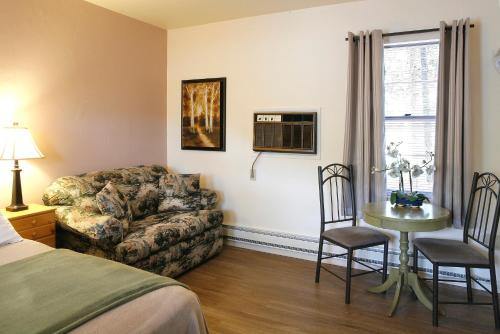 a hotel room with a bed and a couch and a table at Peninsula Park-View Resort in Fish Creek