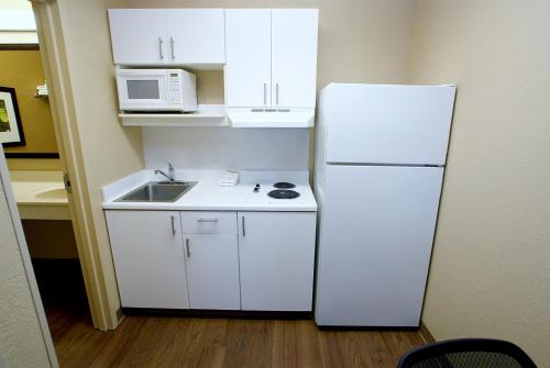 a kitchen with a white refrigerator and a sink at Extended Stay America Suites - Nashville - Brentwood - South in Brentwood