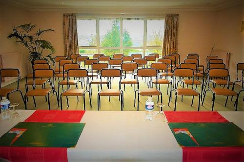 a conference room with a table and chairs in it at Logis Hotel Altina in Pacy-sur-Eure