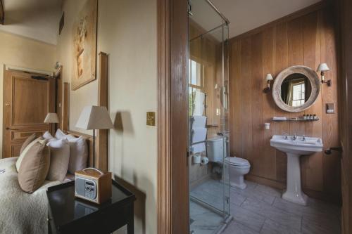 a bathroom with a bed and a sink and a toilet at The Orange in London