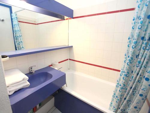 La salle de bains est pourvue d'un lavabo bleu et d'une baignoire. dans l'établissement #Cannes Boccacabana Beach, Seafront, in Résid Pierre&Vacances Classé 3 Stars, à Cannes