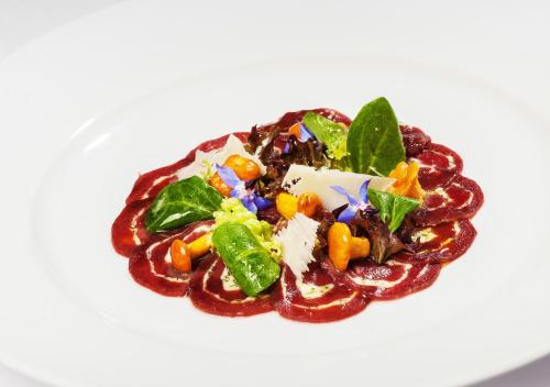 a dish of food on a white plate at Gasthof Engelhof in Gmunden