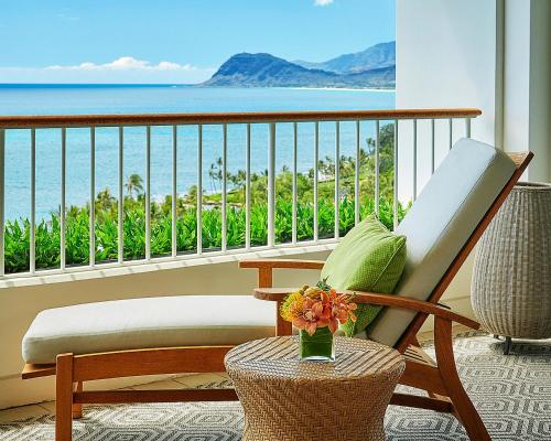 a balcony with a chair and a view of the ocean at Four Seasons Resort Oahu at Ko Olina in Kapolei