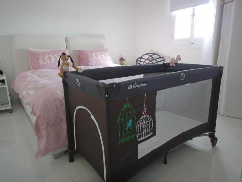 a black bed with a cage on it in a bedroom at JB Villa in Mesaria