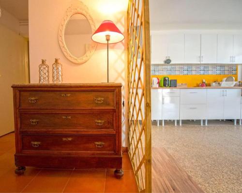 a kitchen with a dresser and a lamp in a room at Inn Golegã in Golegã