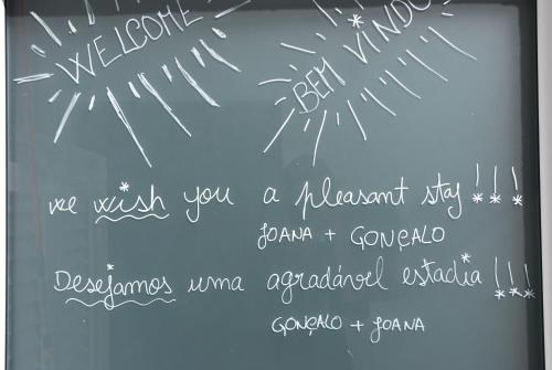 a chalkboard with some writing on it at Stressfree Suite in Vila Nova de Milfontes