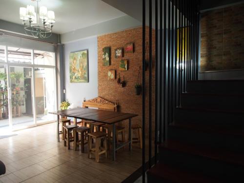 una sala da pranzo con un tavolo e un muro di mattoni di Sriyanar Place a Bangkok