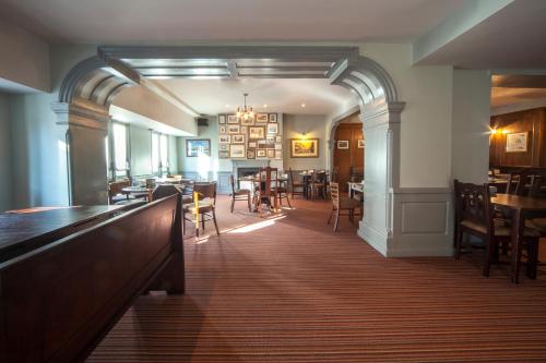 
a kitchen area with a dining table and a large window at The Cathedral Hotel in Salisbury
