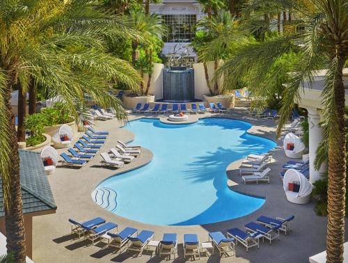 an overhead view of a pool with chairs and palm trees at Four Seasons Hotel Las Vegas in Las Vegas