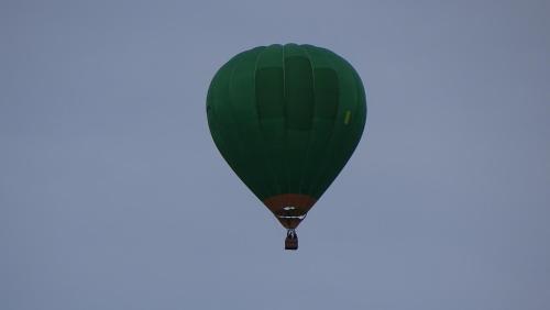 a green hot air balloon in the sky at Hotel Cardamomo Sigüenza in Carabias