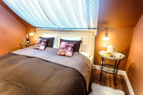 a bedroom with a bed with a blue window at Chateau Nightingales in Hostouň