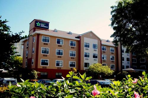 a building with a clock on top of it at Extended Stay America Premier Suites - Miami - Airport - Doral - 87th Avenue South in Miami