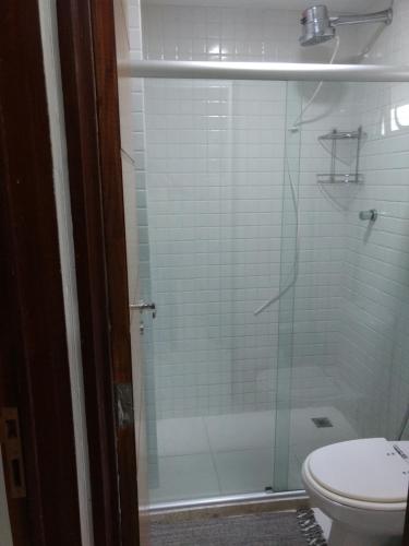 a bathroom with a glass shower with a toilet at Terrazzas Flat in João Pessoa