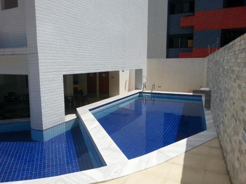 a swimming pool in the middle of a building at Terrazzas Flat in João Pessoa