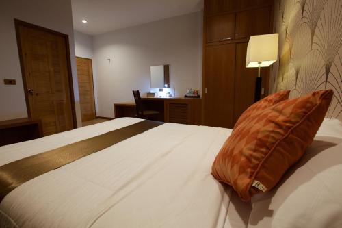 a bedroom with a bed with a pillow on it at 777 Food & Bed in Chiang Rai