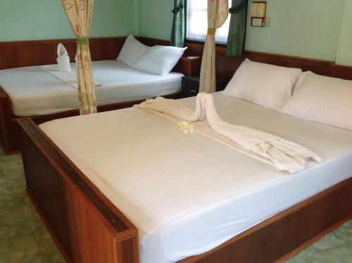 Postel nebo postele na pokoji v ubytování Family Tanotebay Resort