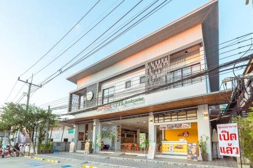 a building with a balcony on the side of it at 777 Food & Bed in Chiang Rai