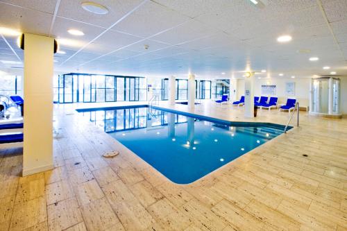 a large swimming pool in a large room at Mt Buller Chalet Hotel & Suites in Mount Buller