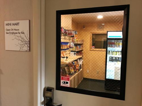 a mirror on the wall of a grocery store at Ramada by Wyndham Draper, Utah in Draper