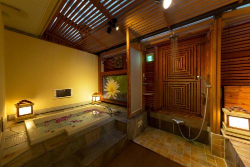 a large bathroom with a tub and a shower at Hotel Lotus Nara (Adult Only) in Nara