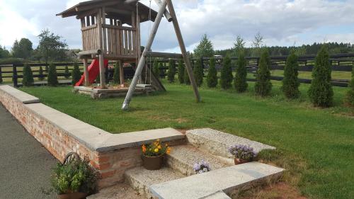 a park with a playground with a swing at Pension Konírna in Huntířov