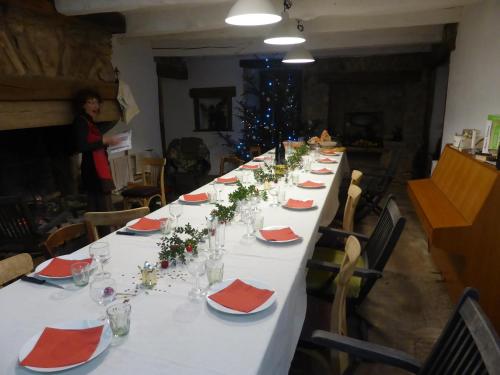 a long table in a room with a christmas tree at La Bouriotte in Labastide-Rouairoux