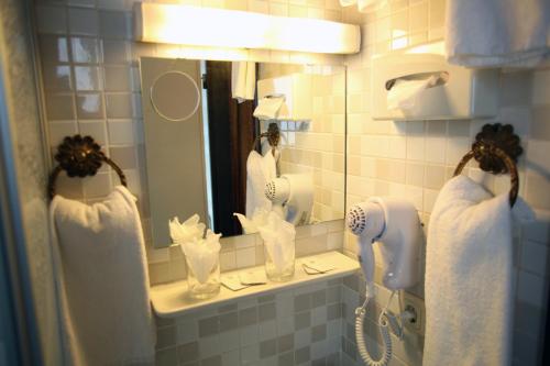 a bathroom with a blow dryer and a mirror at Hotel Lafayette in Hamburg