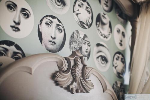 a wall full of faces on a wall at Rum Doodle, Windermere B&B in Windermere