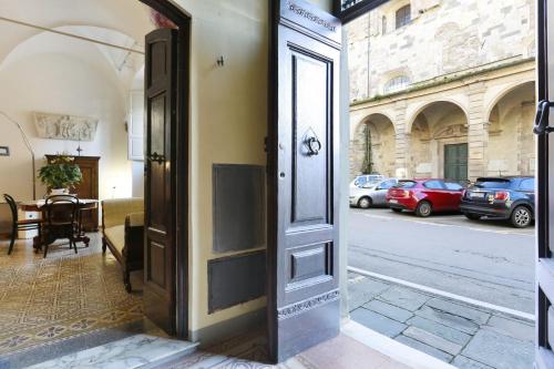 an open door to a room with a table and cars at B&b Pergola House in Lucca