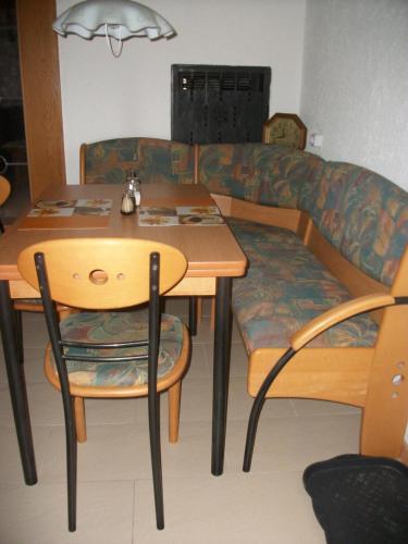 a living room with a table and a couch at Haus Alpenrose in Schwangau