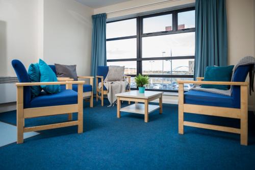 a room with chairs and a table and a window at Newport Student Village (Campus Accommodation) in Newport