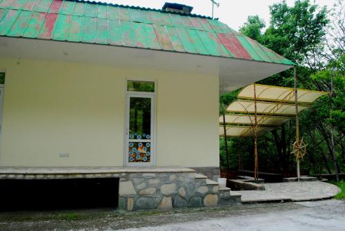 a small white building with a roof and a window at Park-Hotel Khoren's Lake in Areni