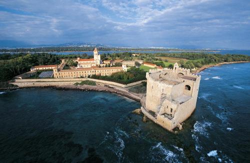 an aerial view of a castle in the water at Hotel Le Festival in Cannes