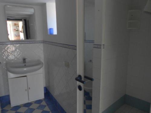 a bathroom with a sink and a shower with a mirror at Monolocali Giancos in Ponza
