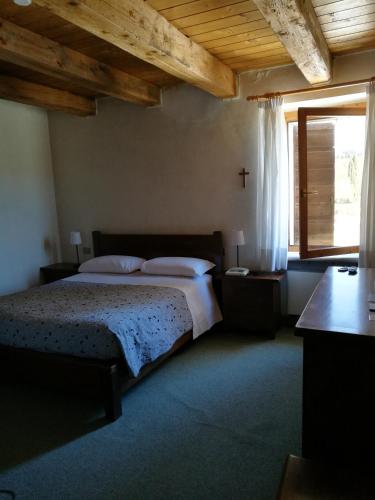 a bedroom with a bed and a cross on the wall at Costa degli Ulivi in Fumane