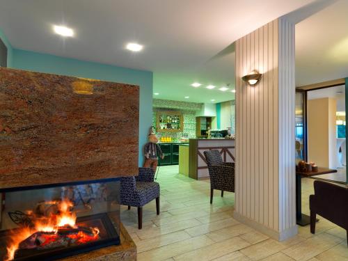 a fireplace in a living room with a fire place at Hotel Green in Dolný Kubín