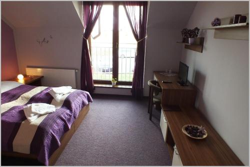a bedroom with a bed and a desk and a window at Hotel Golf Bitozeves in Bitozeves